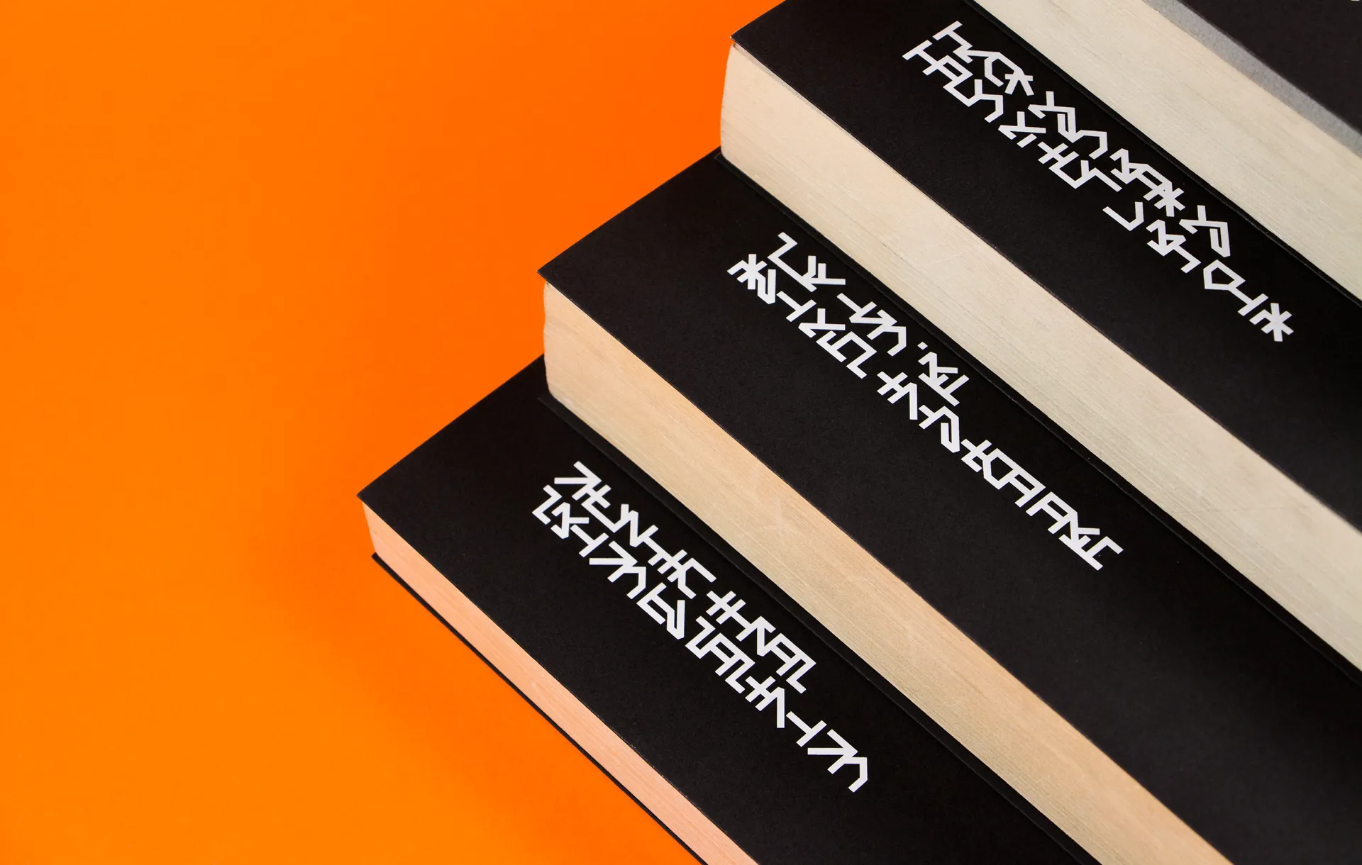 Black and white book cover details on a bright orange background